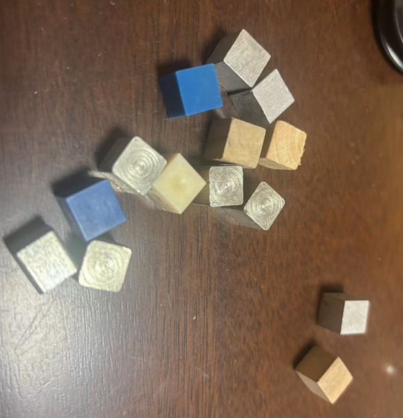 Cubes made from different  materials (rubber , wooden, opaque plastic , metal, transparent plastic )